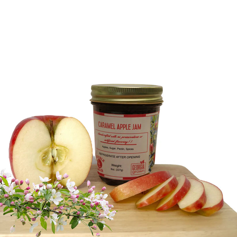 Double L Ranch Caramel Apple Jam jar on a board with fresh apple slices