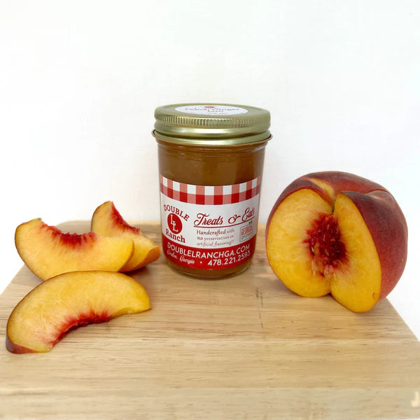 Double L Ranch Peach Ginger Jam jar on a board with fresh peaches