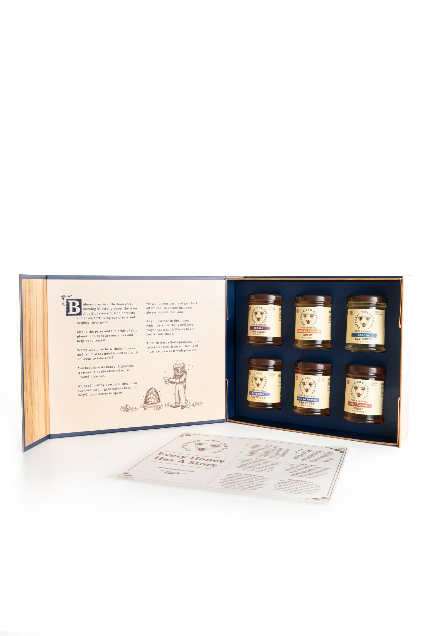 Open Savannah Bee Company Book of Honey with six 3oz honey jars and story page displayed